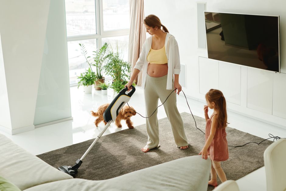 Vacuuming a bright, modern living room carpet
